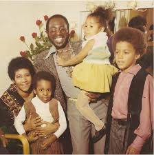 Curtis Mayfield with his children along Aretha Franklin with Curtis  Mayfield's mother.