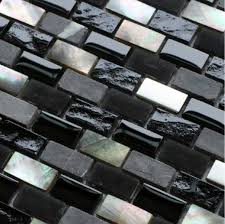 The backsplash is uniquely wrapped in shorter and skinnier subway tiles. Modern Kitchen Gray And Black And Silver Tile Backsplash Grey Stone Mosaic Black Glass Mo Grey Stone Mosaic Stone Backsplash Kitchen Kitchen Tiles Backsplash