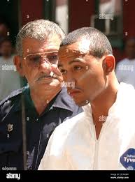 Cletus C. Rivera, 24, is escorted by Reading Police Officer Anthony  Miccicke to an arraignment at District Judge Wally Scott's office in  Reading, Pa., Sunday, Aug. 6, 2006, for his involvement in