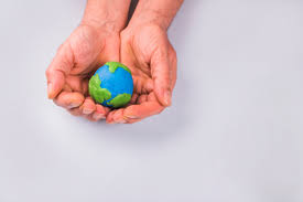 Hands Of Child Holding Colorful Clay Model Of Planet Earth