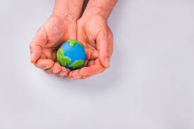 hands of child holding colorful clay model of planet earth