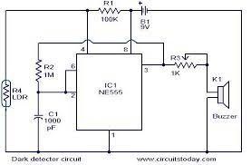 This is a dark detector circuit that utilizes 1) the astable ocillator that you can make with a 555 to drive a piezo and 2) the reset threshold of the chip. Dark Detector Circuit
