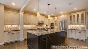 Choose from elegantly scrolled corbels and beautifully turned legs to accentuate the dignity of fine door details, like those found in these dreamy, cream cabinets with glaze, shown here in selena maple coconut with grey stone glaze. Belfast Cream Glaze Real Gallery 3