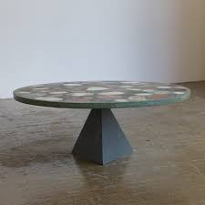 With its round oak tabletop and thin sheet steel legs, it creates a practical and appealing look. Terrazzo Coffee Table With Metal Pyramid Base 1980s 166885