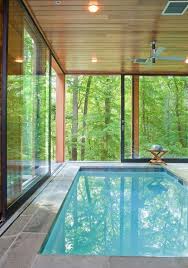 The clear sides make the interior visible giving the pool a futuristic appearance. Indoor Pool With Nature Views Home Decorating Trends Homedit Indoor Swimming Pool Design Small Indoor Pool Indoor Pool Design