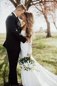 Long Sleeve Lace Wedding Dress Curly Hair Down Wedding Groom In A Black Tux In 2021 Long Sleeve Wedding Dress Lace Bridal Poses Wedding
