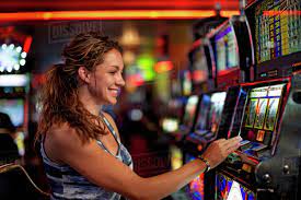 Caucasian woman playing slot machine in casino - Stock Photo - Dissolve