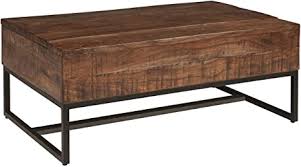 Coffee table's top lifts to reveal storage compartments. Amazon Com Signature Design By Ashley Hirvanton Lift Top Cocktail Table Warm Brown Furniture Decor