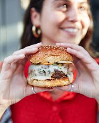 Organic grass-fed beef, Alice's harissa aioli, roasted onions, Israeli  pickles all