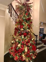 This wonderful christmas tree looks fancy and cozy at the same time. Traditional Red Gold And Green Christmas Tree Designed By Arcadia Floral And H Red And Gold Christmas Tree Green Christmas Decorations Holiday Christmas Tree