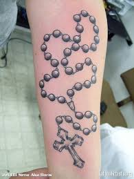 A watercolor style bird is rendered in black and orange ink in this tattoo depicted on the wearer's ribcage. Rosary Arm Tattoo Designs Arm Tattoo Sites