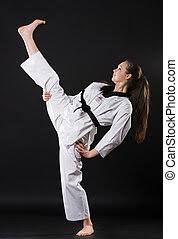 Tokyo 2020 karate day 2: Portrait Of Martial Arts Girl In Kimono Exercising Karate Kata Against Dark Background Canstock