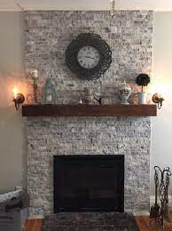 From traditional, deep wood facades to classic stone carved mantels, we are sure to have a free standing electric fireplace that's perfect for your home. Silver Travertine Stacked Stone And Reclaimed Wood Mantel Renovated Old Chimney That Was In Bad Sh Stone Fireplace Mantel Fireplace Design Fireplace Remodel