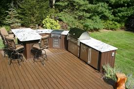 Covered outdoor stone kitchen with patio dining area. Designing Outdoor Kitchens Jlc Online