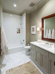 A small woven baskets sits on beige mosaic floor tiles in front of a beige oak washstand accented with a white quartz countertop. Grey Bathroom Vanity With Beige Wall Salle De Bain Beige Decoration Murale Salle De Bains Decoration Salle De Bain