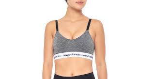 The bra's adjustable straps have back hooks, are cushioned, and do not dig into the shoulders. New Balance Synthetic Adjustable Strap Sports Bra In Black Lyst