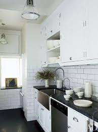 I would tile under the cabinets, as it would keep the opening height correct for appliances (34 1/2). 23 Ways To Decorate With Subway Tile Architectural Digest