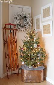 Decorate a christmas sled with a wreath and words. Our Christmas Entryway