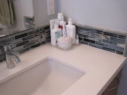 In this space, designer andreas charalambous chose slim glass tile in calming shades of brown and beige, complementing the wenge countertop and floating display boxes. Mosaic Tiles Corner Bathroom Sink Small Bathroom Sinks Backsplash Bathroom Sink Bathroom Decor