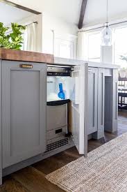 A Stainless Steel Ice Maker Is Concealed Behind A Cabinet Door Of A Gray Blue K Kitchen Countertops Pictures Affordable Kitchen Countertops Ice Machine Kitchen