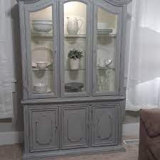 A charcoal gray freestanding island with turned legs is accented with polished nickel pulls and a wood countertop lit by seeded glass conical light pendants. Find More Grey Chalk Painted Distressed China Hutch For Sale At Up To 90 Off