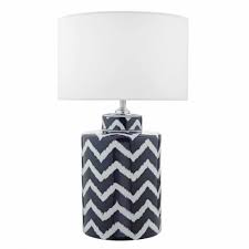 The round hardback drum shade is a white linen fabric. Ceramic Table Lamp Base With Zig Zag Pattern