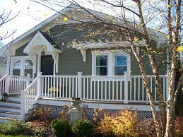 Bright landscaping and double porches. Sixty Fifth Avenue Craftsman Style Cottage Porch Design House Front Porch House With Porch