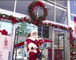 Image of people shopping at Academy Sports with Christmas decorations in the background