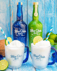 There's a blue rocking chair sitting in the sand weathered by the storms . Frozen Key Lime Colada Cocktail Recipe Key Lime Rum Cream Key Lime Rum Recipes Rum Cream