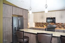 This Kitchen Design In Holt Mi Features Two Toned Textured Laminate Kitchen Cabinets F Warm Kitchen Colors Schemes Kitchen Design Color Latest Kitchen Designs