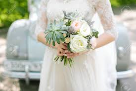 If you need different quantity, different colors or matching decoration items please contact us for a custom price quote. Beautiful Woman In A White Wedding Dress Holding A Flowers Bouquet Stock Photo Picture And Royalty Free Image Image 76127376