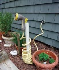 Clever Storage For Coiled Hoses Finegardening Diy Garden Projects Garden Hose Storage Garden Projects
