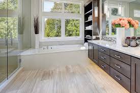 This bright kitchen's wood floors complement the cabinetry and the tile used in the workspace of the kitchen to balance out the use of dark cabinets and countertops, which look stunning, a light floor and glass door cabinets punctuate the uniformly natural wood look. Vinyl Flooring With Dark Cabinets Vinyl Flooring Online