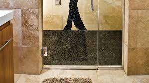 Combine the river rock with a ceramic tiled border near the walls of the bathroom, as an alternative look. River Rock Surface Art Inc