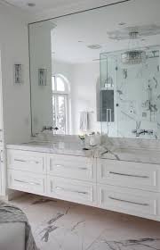 This full wall mirror starts at the level of the vanity and continues all the way up to the ceiling of this stone tile clad bathroom. 30 Cool Ideas To Use Big Mirrors In Your Bathroom Digsdigs