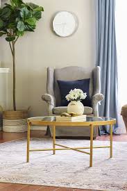 The rectangular table is made from solid mango wood and is supported by four hairpin legs with a gold finish for some retro vibes. All Modern Minimal Spring Living Room Refresh Lucy Jo Home