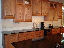 It's a modern look, for sure! Backsplash With Uba Tuba Counter Honey Oak Cabinets Oak Cabinets Black Granite Countertops
