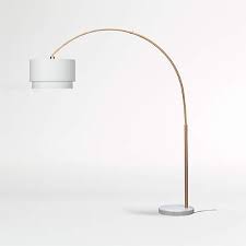 The skirt floor lamp comes with a makeshift end table and hence, this cool floor lamp is perfect for small spaces. Meryl Arc Brass Floor Lamp With White Shade Crate And Barrel