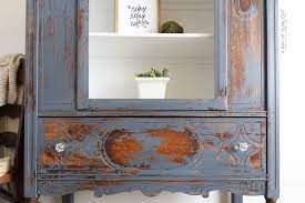 I'm painting, but chalk paint really does stick well even to glossy . Chippy Blue Painted Hutch Makeover