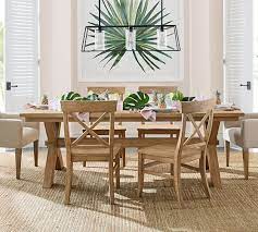 The pedestal table's planked top is eased along the edges and can extend to accommodate additional guests. Toscana Extending Dining Table Pottery Barn