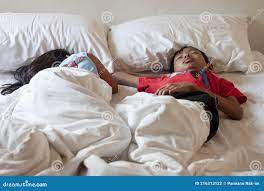 Asian Brother and Sister Sleeping on the Bed. Stock Photo 