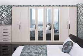 A large wardrobe is installed in the apartment. Fitted Bedroom Designs Anne Wright Interiors Ltd