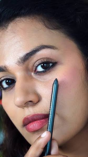Kohl vs Kajal: woman applying black kajal eye makeup for defined eyes