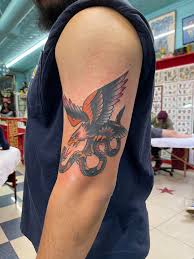 Given that oliver peck started tattooing at the age of 19, it is not surprising that he has made a name for himself as an artist and is in high demand by ink enthusiasts globally. Traditional Eagle With Snake Oliver Peck Elm Street Tattoo Dallas Tx Tattoos
