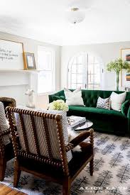 Beautifully Appointed Transitional Living Room Showcases A Stunning Emerald Green Velvet Tu Living Room Green Green Sofa Design Transitional Living Room Design