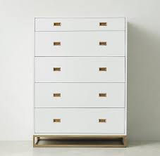 The tall dresser is covered in a 100% cotton fabric, with the drawer fronts covered in a smooth, unexpected tan leather that lends a sense of comfort and calm. White Five Drawer Brass Pulls Tall Dresser