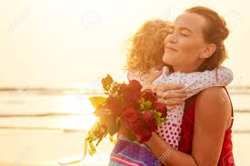 Parents, siblings, kids and even friends would be extremely grateful for valentine's day flowers. Happy Family With Bouquet Of Flowers Roses On The Beach By The Stock Photo Picture And Royalty Free Image Image 130771253