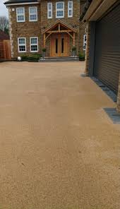 Make sure the resin container is secure (between your feet) before you start mixing. Resin Gravel Driveway Installation For Summer 2019