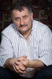 The singular way he pans to follow the simple movements of a waiter in the second section—darting backwards and forwards with uncertainty at his task—is as memorable as the protracted reading of a disquieting letter from the armenian front in the section. Cristi Puiu
