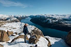 There are thousands of cabins, cottages, lodges, and fisherman's shacks for rent in norway. Traveler Man Standing On The Big Rock On A Cliff And Enjoying The Beautiful View Of The Fjord And Mountains Preikestolen Pulpit Rock Lysefjord Norway Sunny Winter Day Stock Photo Adobe